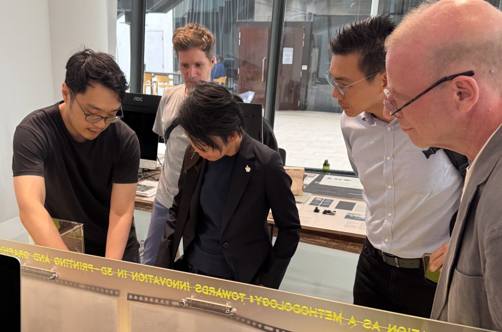 (First from left) Darius Ou explains his prototypes to visitors at the MA Design work in progress show INTERLUDE earlier in May 2025.