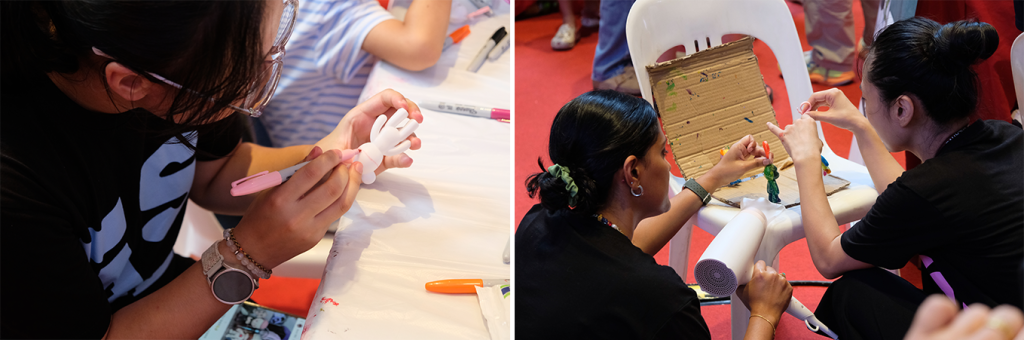 Students working on the bear figurine painting activity with members of the public.